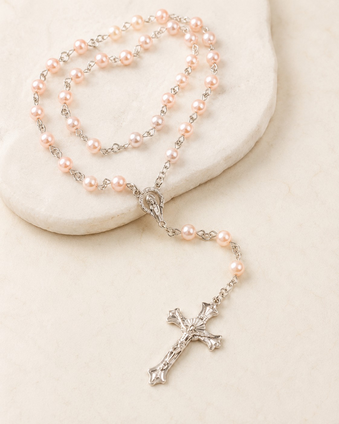 Blush Pearl Rosary styled on a pale dish